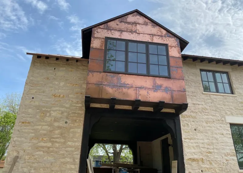 Copper metal panel facade on a stone building for Metal Roof Coating in Midland